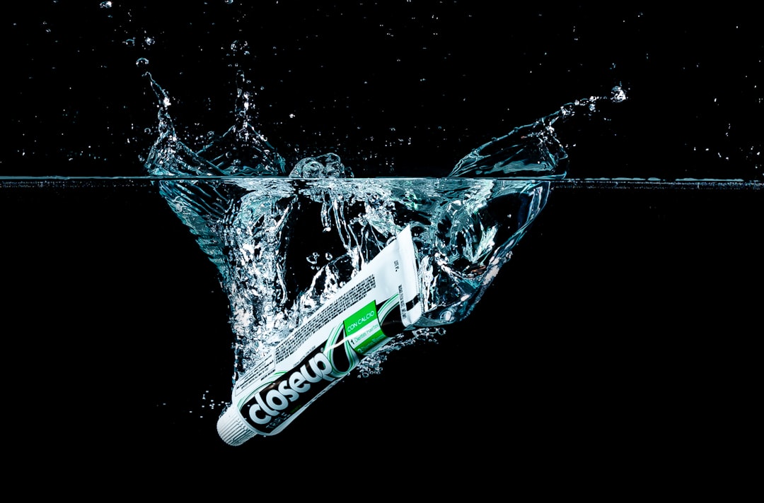 a tube of toothpaste falling into the water