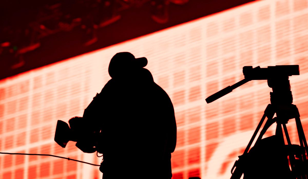 Camera Operator Filming in Front of LED Wall Virtual Scene