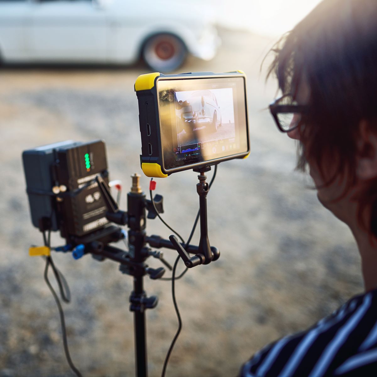 Cinematographer checking footage from phone connected to cloud